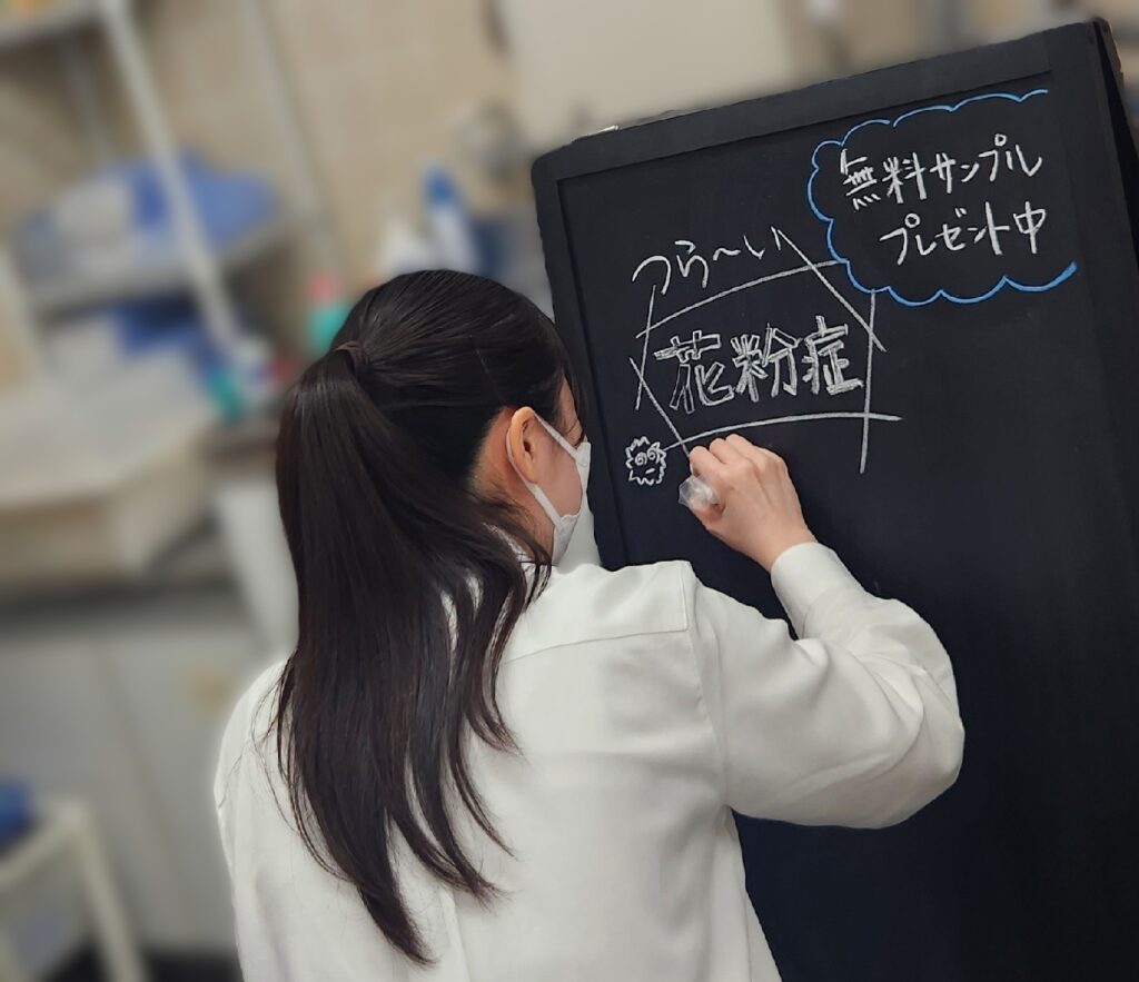 コスモス薬局東船橋店で薬学部実習生が花粉症のA看板を作成している様子